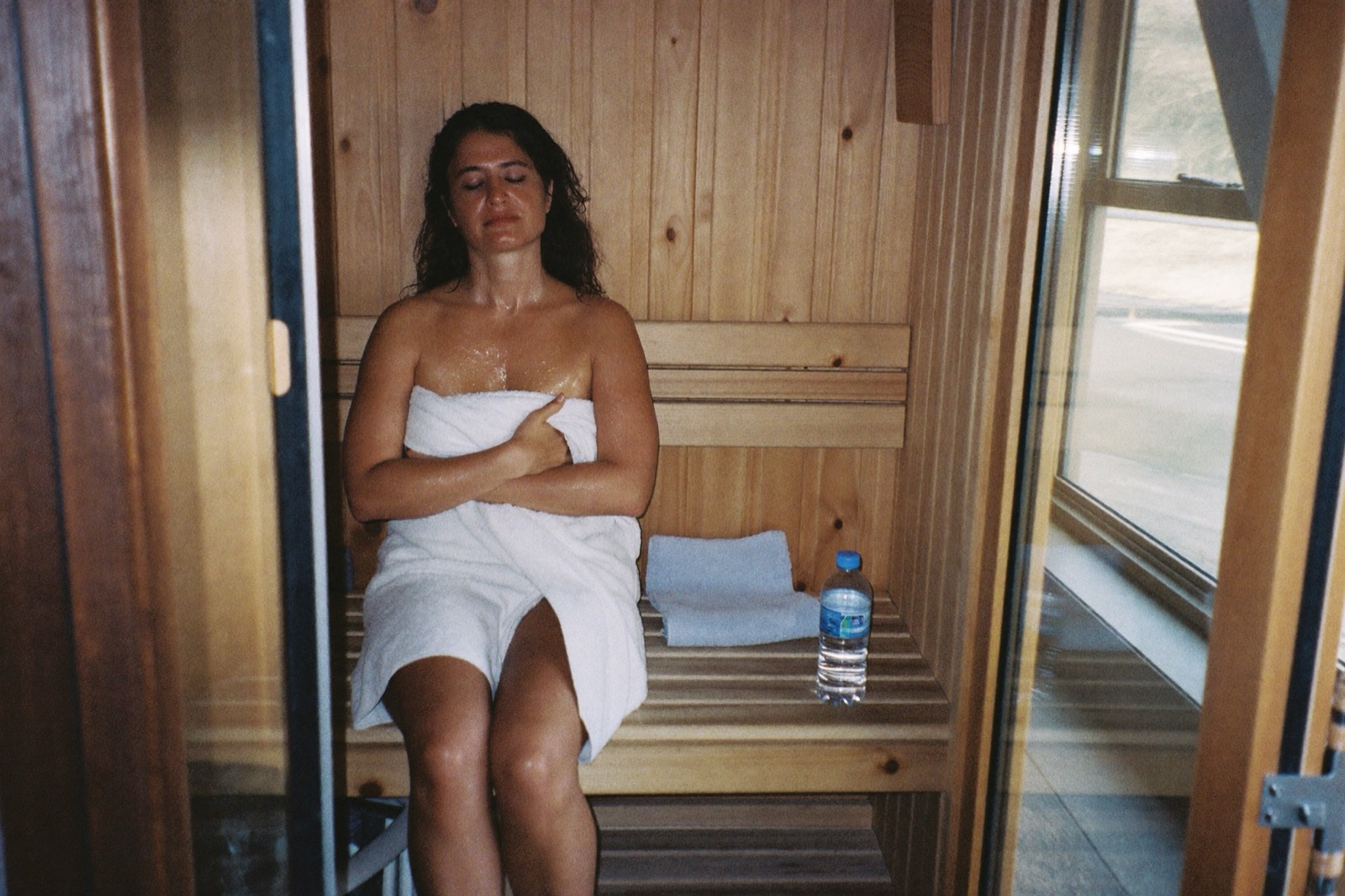 Wooden infrared sauna cabin with bench and heater panels